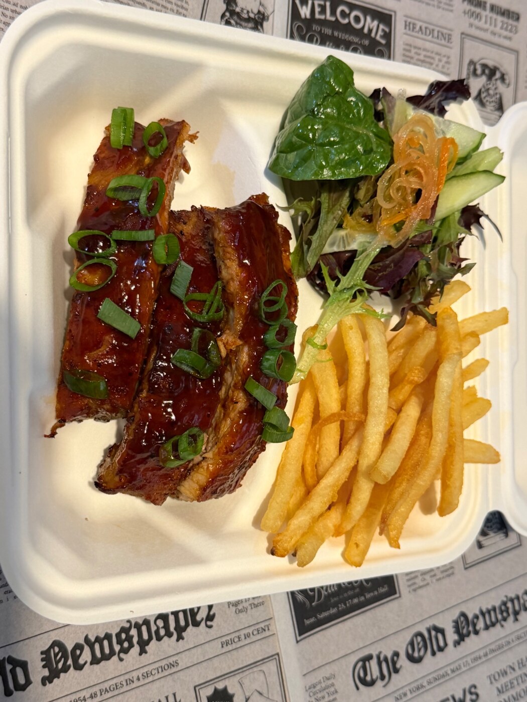 Filipino Fusion BBQ pork ribs with chips and salad