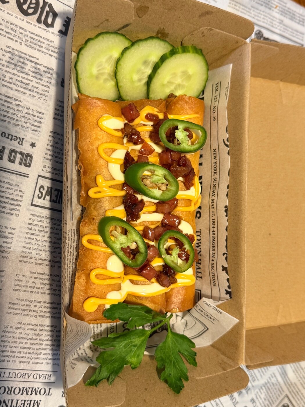 Filipino Fusion loaded lumpia with cheddar, sour cream, bacon and jalapeños